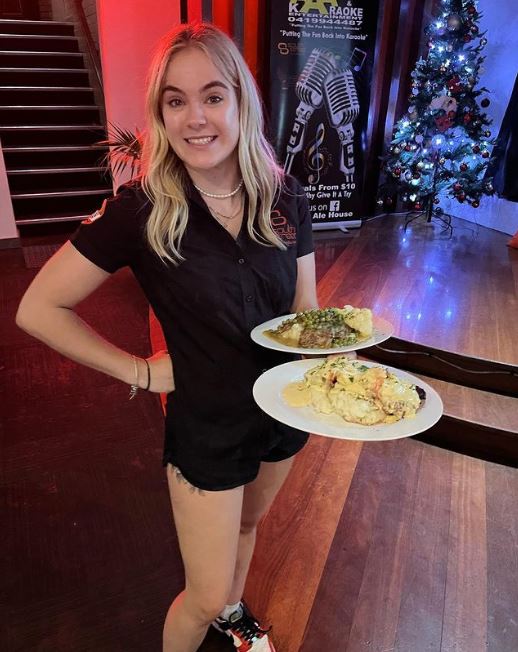 Restaurant staff happily serving food